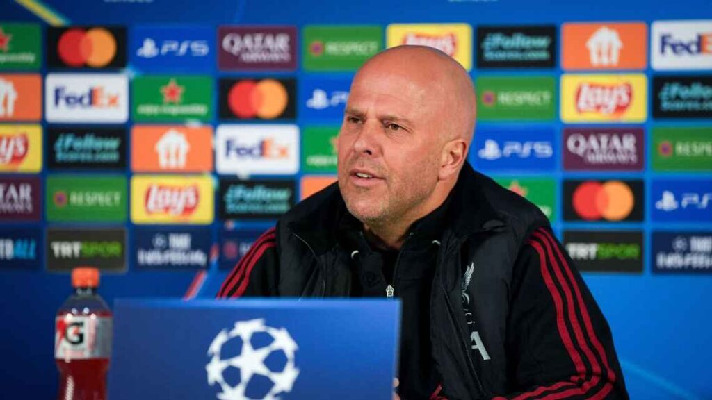 A tight, low-angle shot of a corner flag at RAMS Park with blurred, smoke-filled stands in the background.
