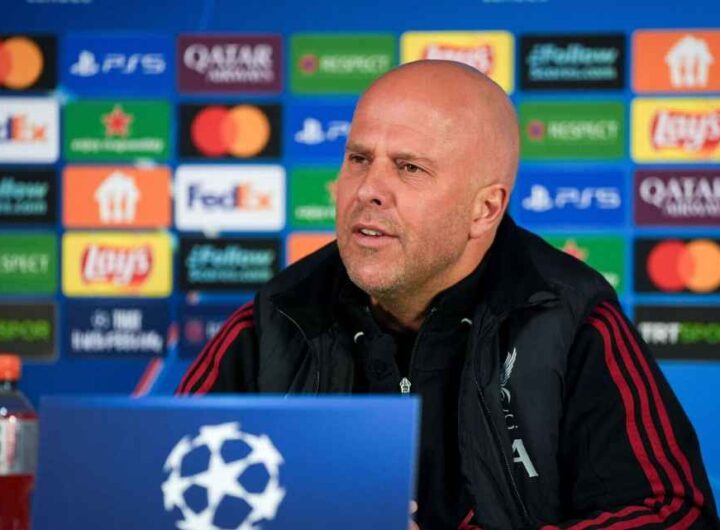 A tight, low-angle shot of a corner flag at RAMS Park with blurred, smoke-filled stands in the background.